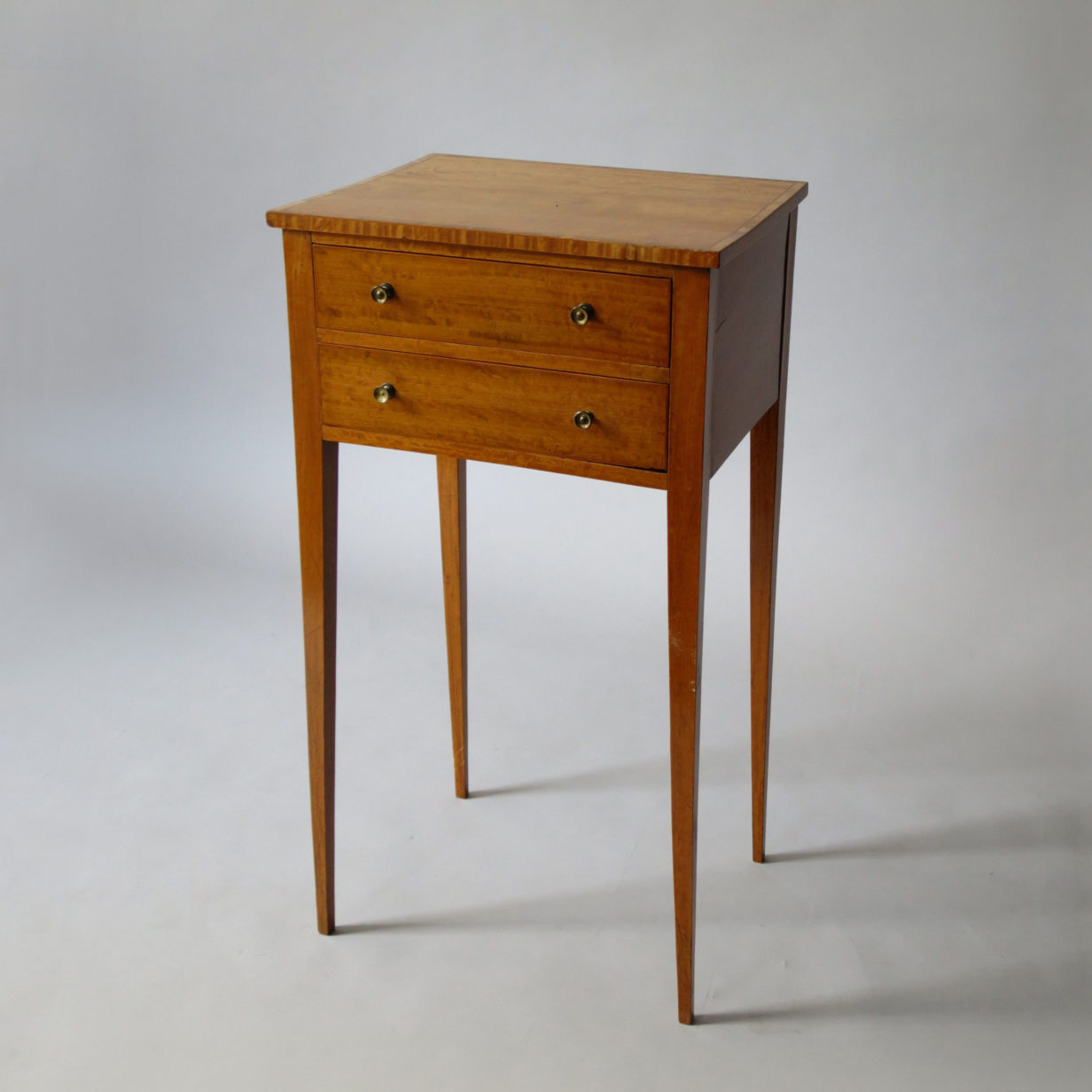 A sheraton satinwood two drawer end table