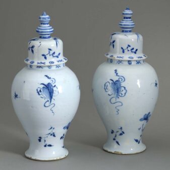Pair of antique delft pottery blue and white glazed vases and covers