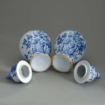 Pair of 18th century blue and white glazed delft pottery vases and covers