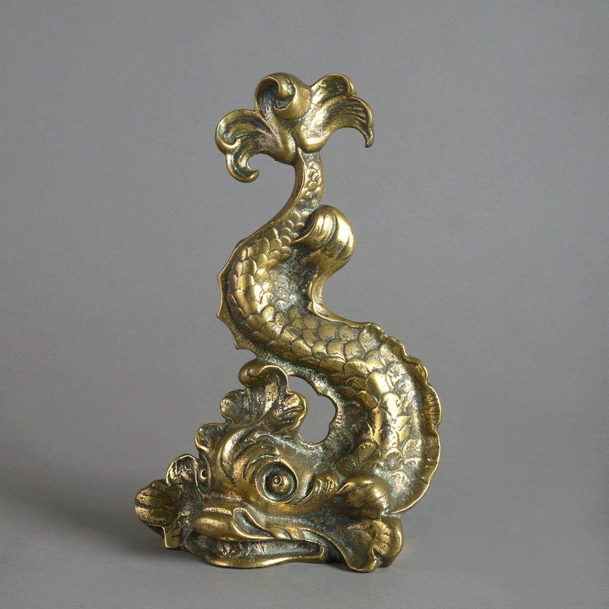 A 19th century victorian dolphin brass doorstop