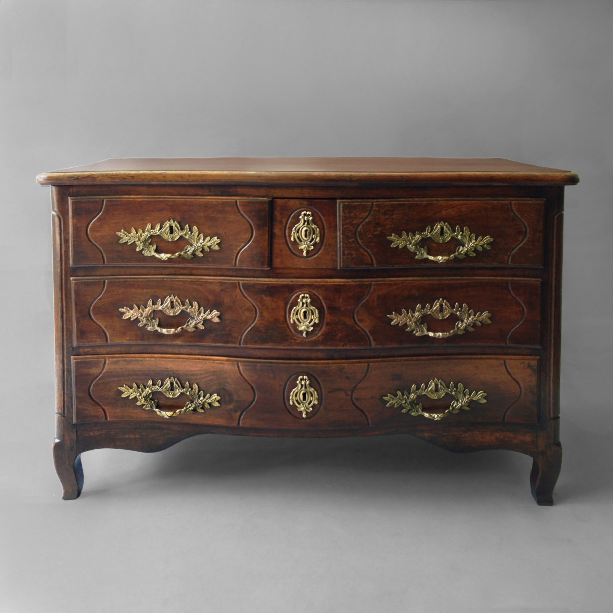 A louis xv walnut three-drawer commode