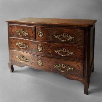 A louis xv walnut three-drawer commode