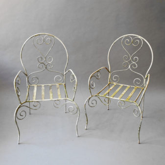 A set of four painted cast and wrought iron garden chairs