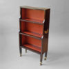 A faux rosewood dwarf bookcase