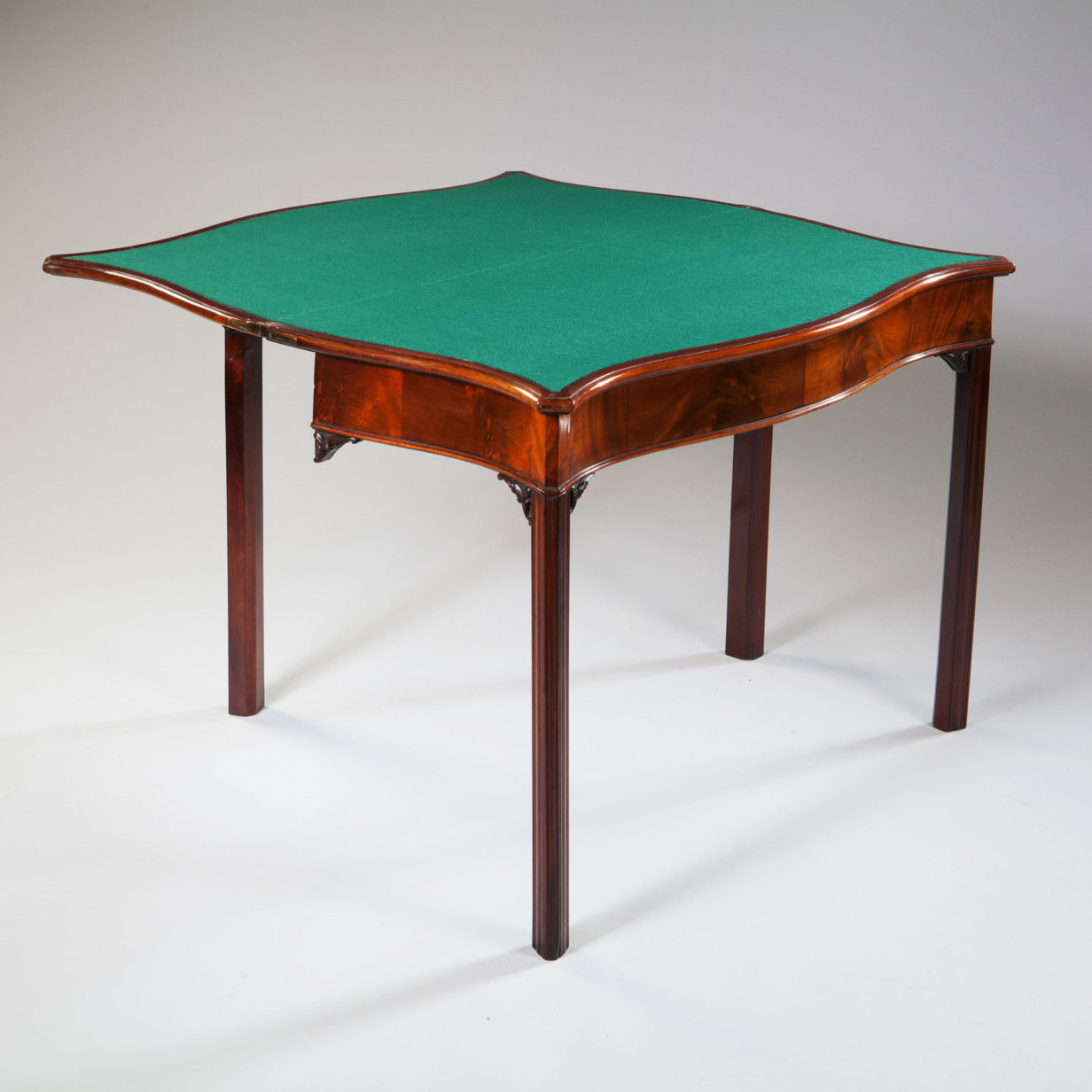 An 18th century george iii period serpentine mahogany card table