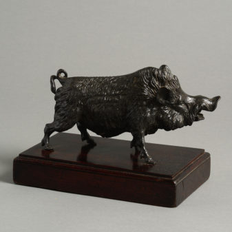 A bronzed metal boar set upon a mahogany plinth