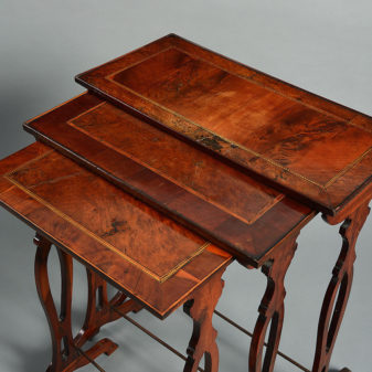 A late 18th century nest of three yew wood tables