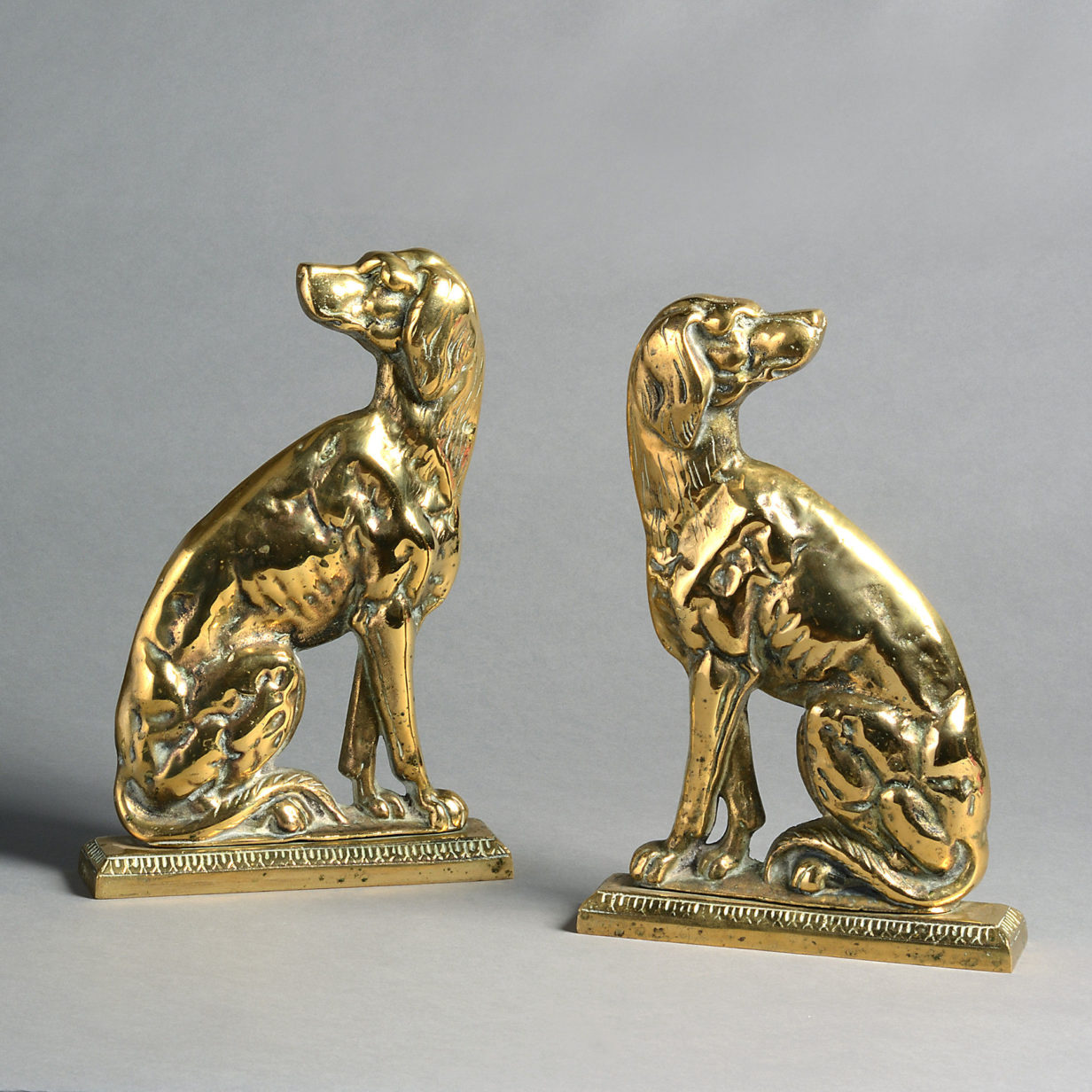 A pair of 19th century brass dog doorstops