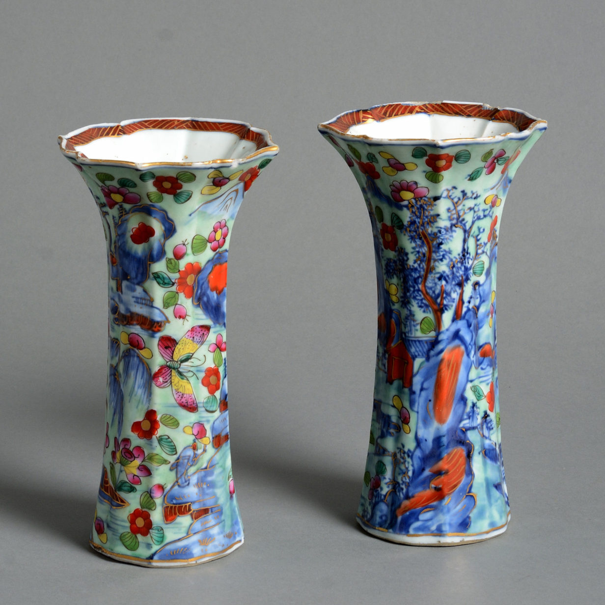 A pair of 18th century clobbered porcelain trumpet vases