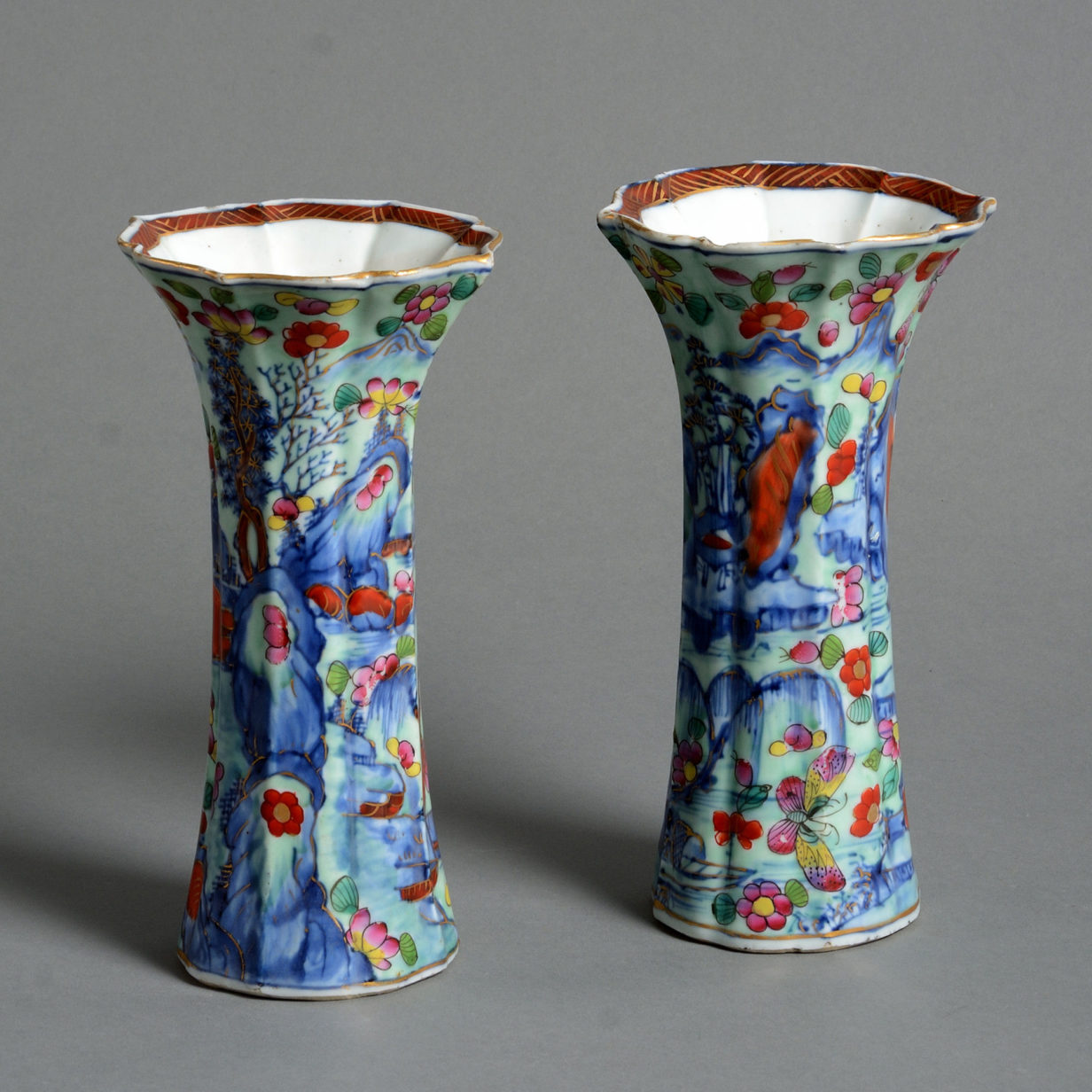 A pair of 18th century clobbered porcelain trumpet vases