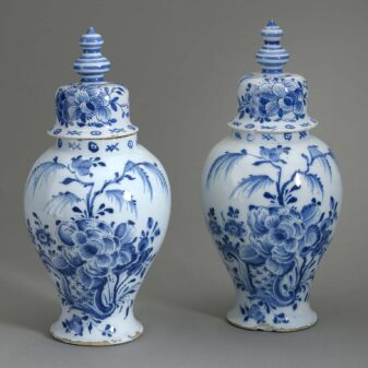 Pair of antique delft pottery blue and white glazed vases and covers