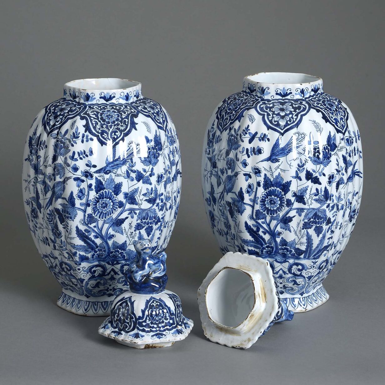 Pair of 19th century blue and white glazed delft vases and covers