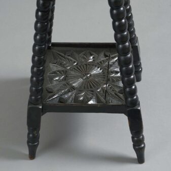 Early 20th century carved ebonised occasional table