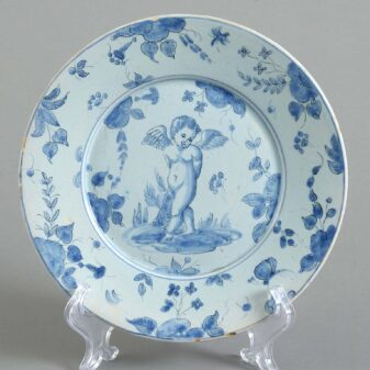 Eight mid-18th century blue and white glazed cupid pattern plates