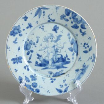 Eight mid-18th century blue and white glazed cupid pattern plates