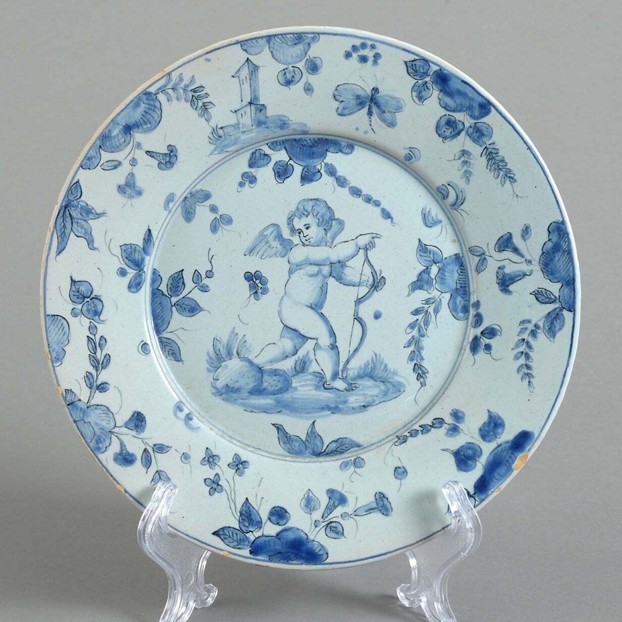 Eight mid-18th century blue and white glazed cupid pattern plates