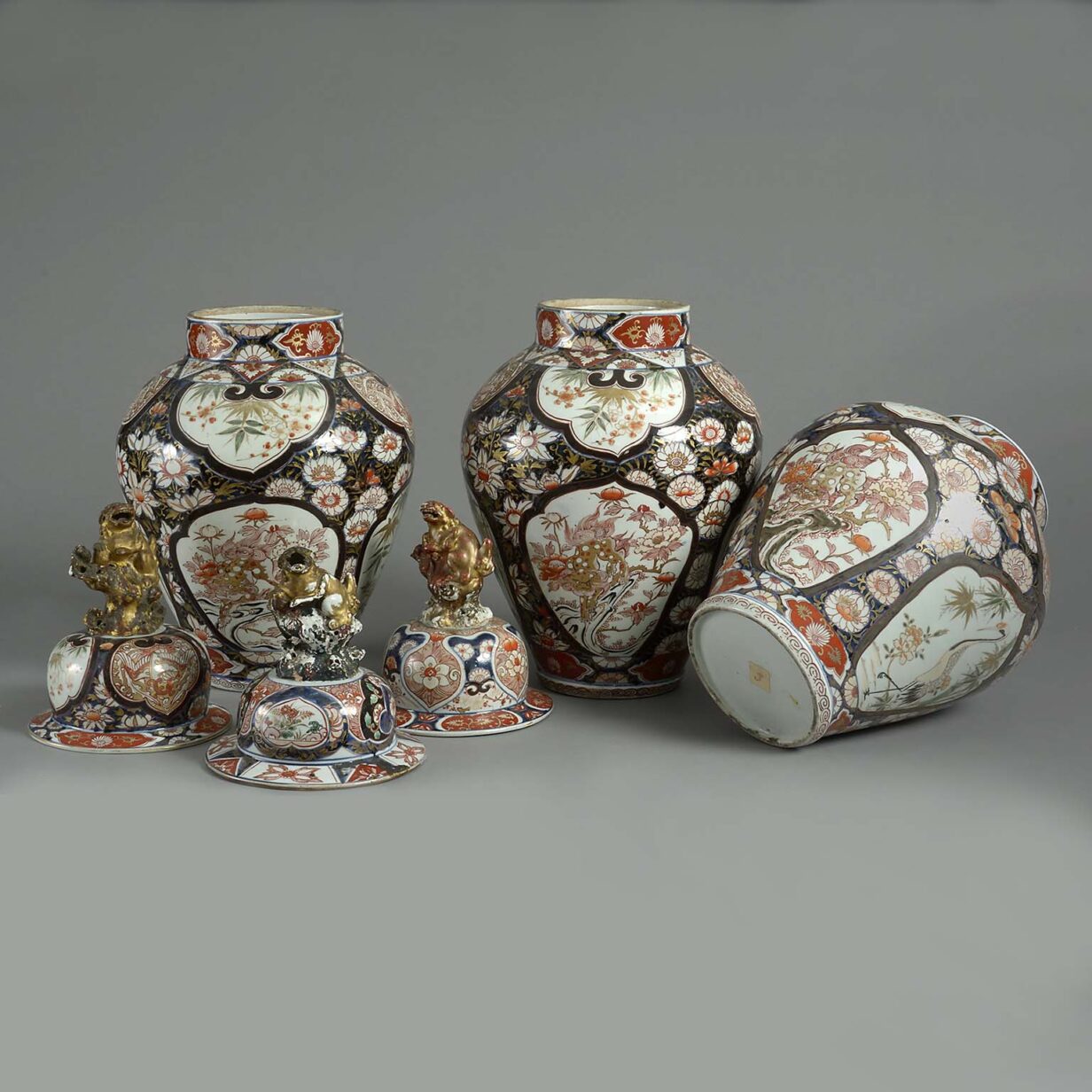 Garniture of three tall late 17th century imari vases