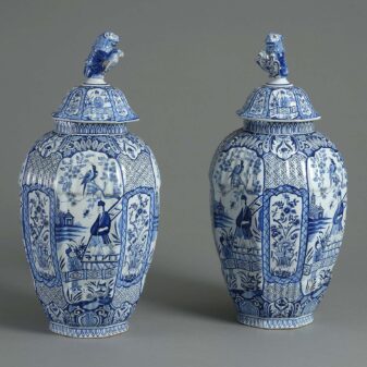 Pair of blue and white delft vases and covers