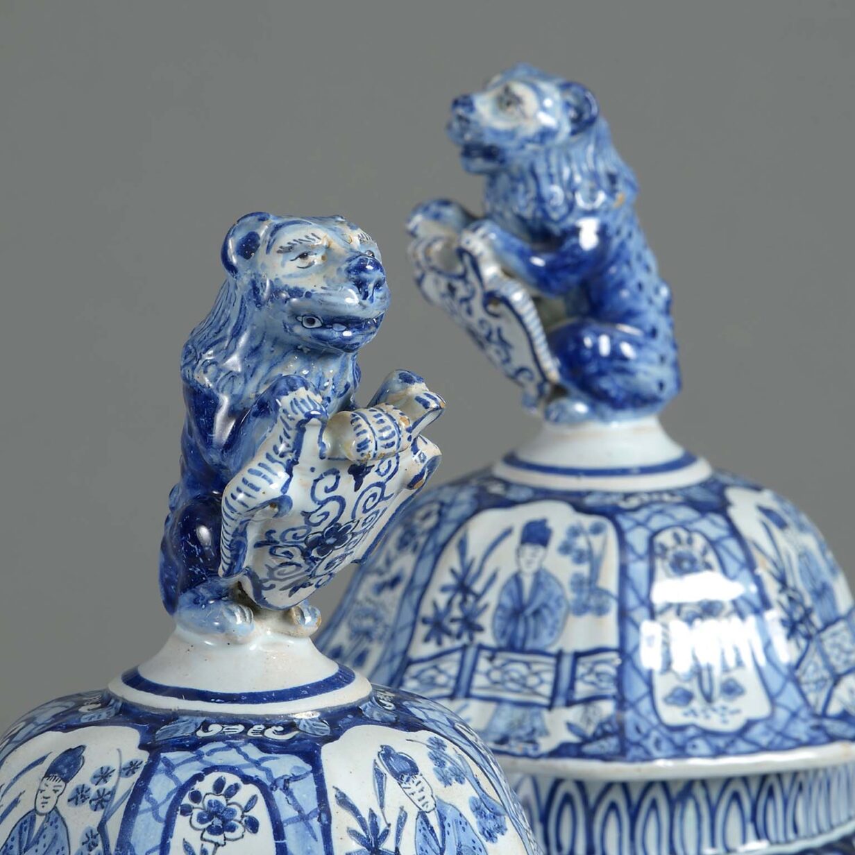 Pair of late 19th century blue and white glazed delft pottery vases and covers