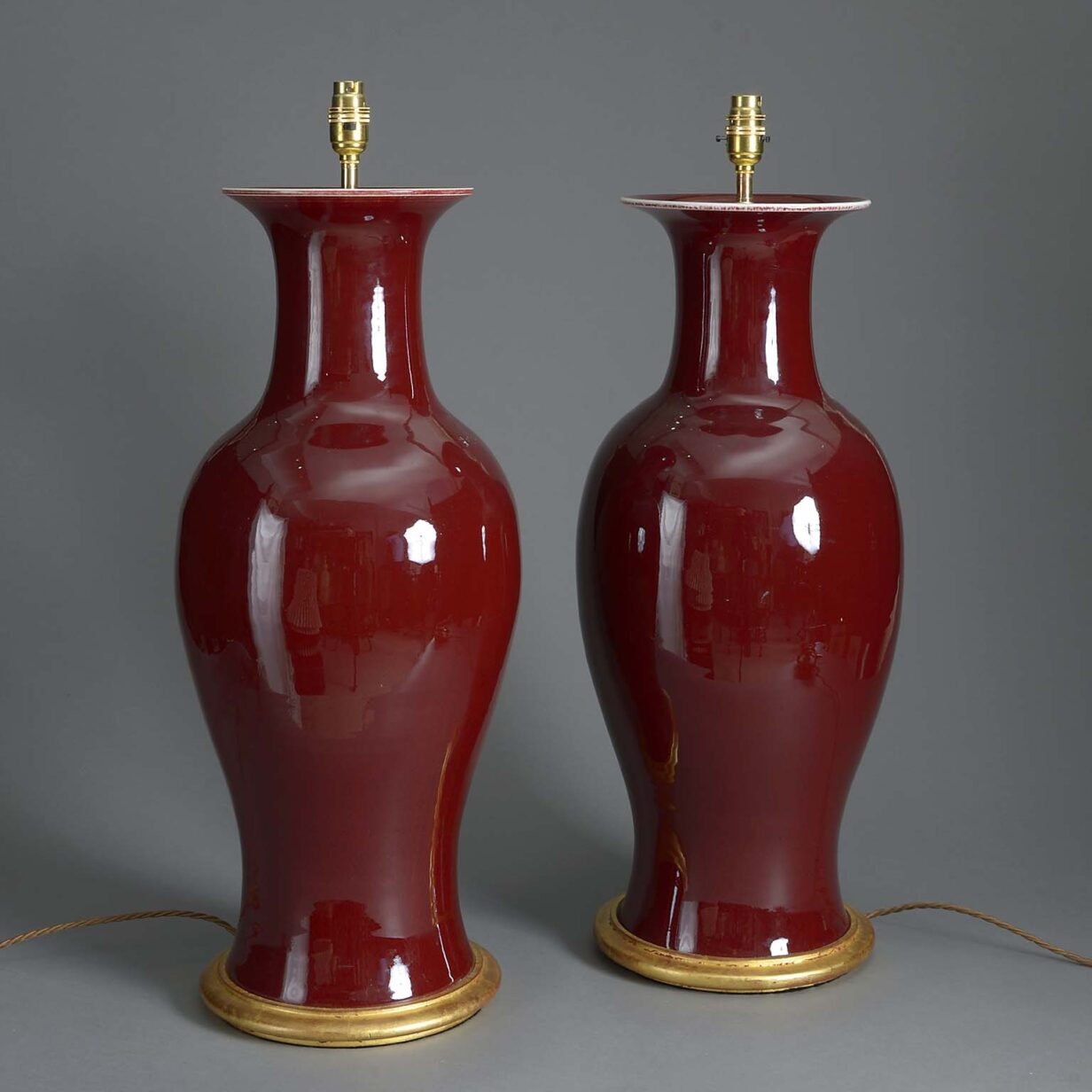 Tall pair of 20th century sang de boeuf porcelain vase lamps