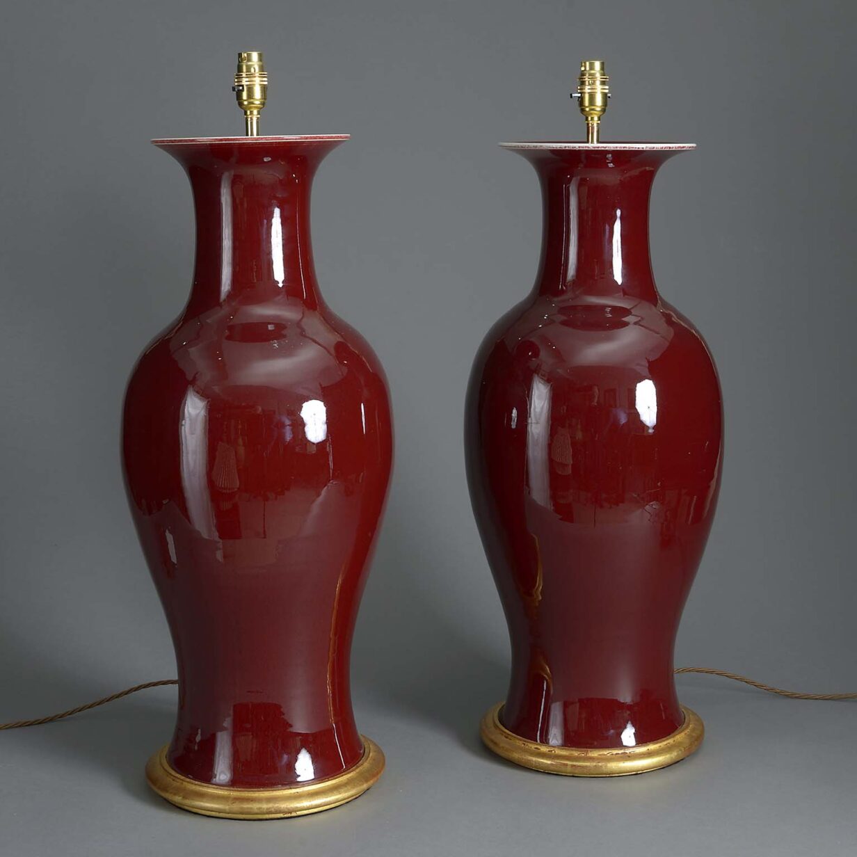 Tall pair of 20th century sang de boeuf porcelain vase lamps